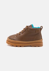 Brown leather ankle boots with a tan rubber sole, featuring a turquoise fleece lining and brown laces. Side logo displayed.