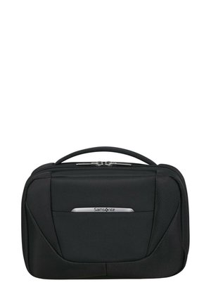 Black Samsonite travel bag with a smooth fabric texture, dual zippers, top handle, and a silver logo accent on the front panel.