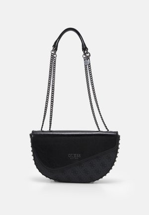 Sac à bandoulière noir en forme de demi-lune avec bandoulières chaîne, surface texturée, bords cloutés et logo "GUESS EST 1981" sur le devant.
