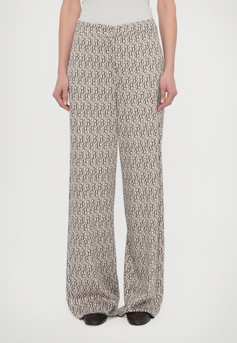 Wide-leg trousers in a lightweight fabric, featuring a repeating geometric pattern in beige, brown, and black with a subtle sheen.