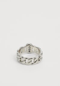 Silver metal ring featuring a chain link design with a smooth finish and a slightly scalloped edge. Displays “ICON” engraving inside.