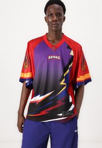 Adidas jersey with a purple, red, and black color scheme featuring lightning bolt graphics, short sleeves, and a v-neck design.
