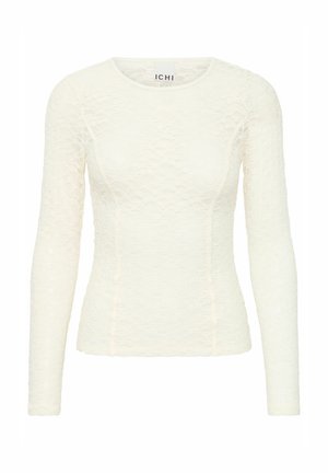 Maglietta a maniche lunghe, aderente in pizzo crema con un motivo testurizzato. Presenta un collo rotondo e dettagli delle cuciture. Etichetta del marchio visibile all'interno.
