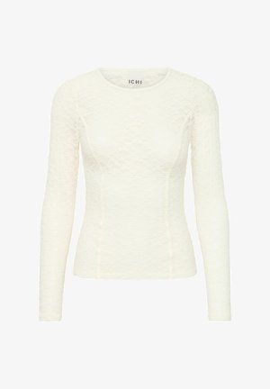 Maglietta a maniche lunghe, aderente in pizzo crema con un motivo testurizzato. Presenta un collo rotondo e dettagli delle cuciture. Etichetta del marchio visibile all'interno.