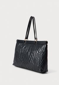 Black quilted leather handbag with smooth texture, dual handles, gold hardware accents, and a structured rectangular shape.