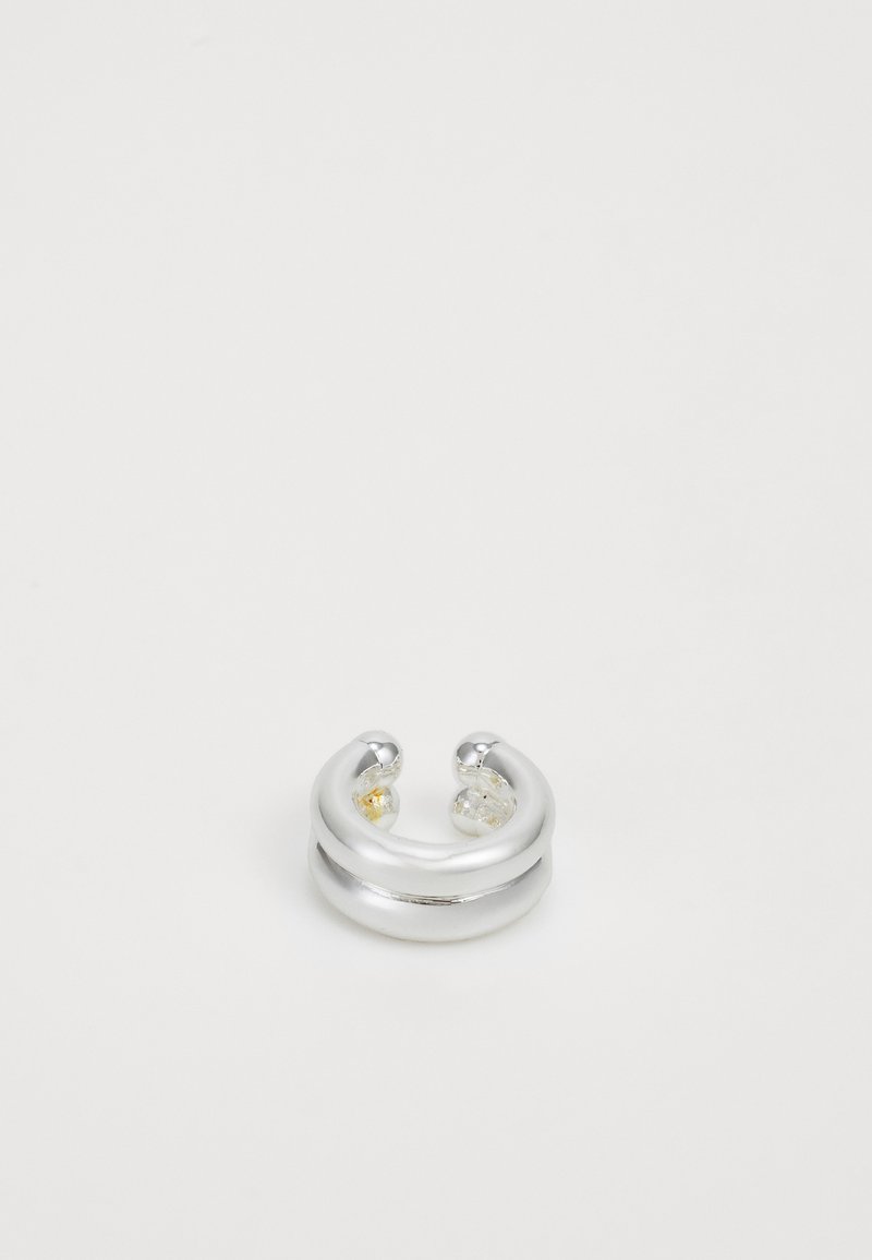 Inel din metal argintiu cu o finisare netedă, având două mărgele decorative – una clară și una galbenă – așezate la fiecare capăt. Design rotunjit.