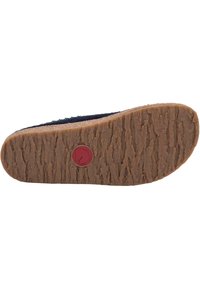Cork sole with a textured surface, featuring a circular red logo. The upper material is dark, with a smooth finish.