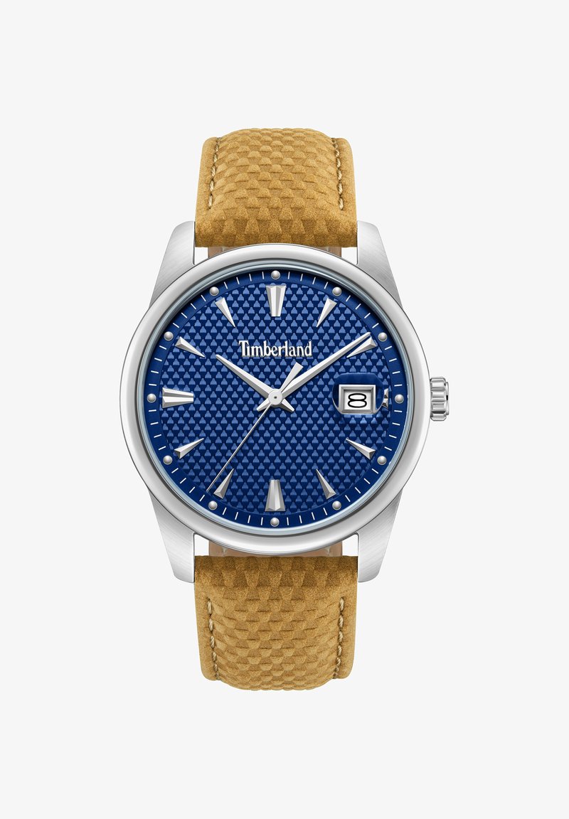 Montre-bracelet analogique Timberland avec cadran bleu texturé, index argentés, affichage de la date à 3 heures, et bracelet en cuir brun clair à motif.