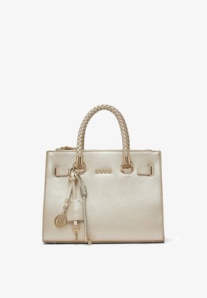 Sac à main beige texturé avec anses tressées, ferrures dorées, pompons décoratifs suspendus et le nom de la marque Liu Jo à l'avant.