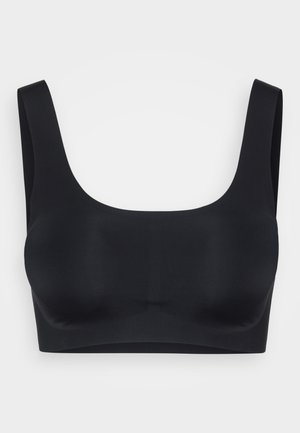 Fekete bralette széles pántokkal, mély kivágással és varrás nélküli kialakítással. Simító, rugalmas anyagból készült a kényelem és a támasz érdekében.