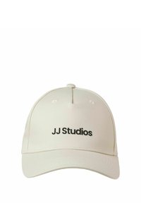Beige cap made of fabric with a curved visor and embroidered black "JJ Studios" logo on the front. Features a button on top and stitching details.
