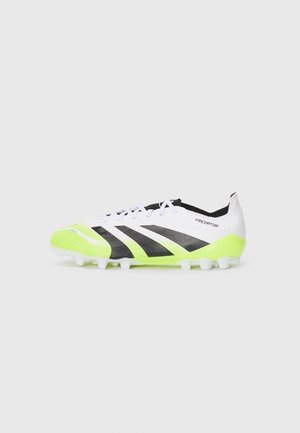 White and black soccer cleat with neon green accents, textured upper, six white studs, and a modern streamlined design.