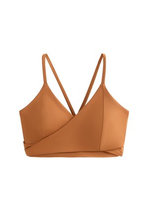 Bralette marrone realizzata in tessuto morbido, con un design incrociato sul davanti, spalline sottili regolabili e una forma pulita e minimalista.
