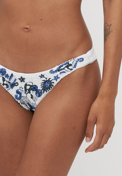 White bikini bottom featuring intricate blue and black bead embroidery with sea creature designs. Smooth, soft fabric with a low-rise cut.