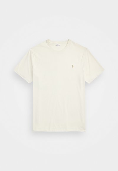 T-shirt z krótkim rękawem w kolorze kremowym, wykonany z bawełny, z małym haftowanym logo na lewej piersi. Gładka tekstura, okrągły dekolt.