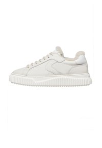 White low-top sneaker with textured leather upper, thick ridged sole, and plush fur lining visible around the ankle collar.