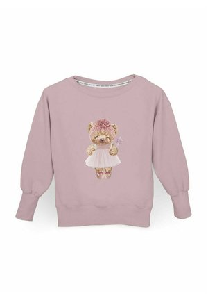 Różowy sweter z długim rękawem, na którym znajduje się postać misia w sukience i opasce na głowie, ozdobiony kwiatowymi wzorami i trzymający różdżkę w ręku.