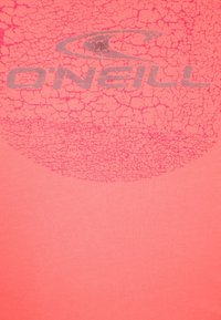 Logo de la marque O'Neill en gris avec une texture fissurée sur un fond en tissu rose corail.
