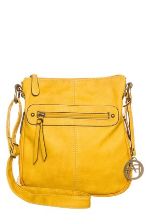 Yellow leather crossbody bag with a front zipper pocket, adjustable strap, and a round metal logo charm. Smooth texture, minimalist design.