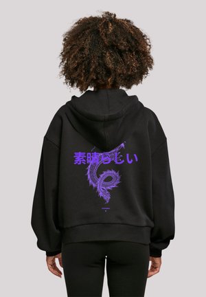 Black oversized hoodie with a purple dragon graphic and Japanese text on the back. Features a drawstring hood and ribbed cuffs.