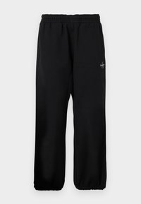 MONOLOGO - Tracksuit bottoms - black