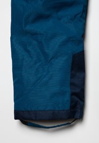 Blue and dark navy fabric sleeve with a black adjustable strap at the bottom edge.