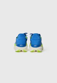 Blue athletic shoes with textured fabric uppers, lime green accents, and a white midsole featuring a unique design and padded collar.