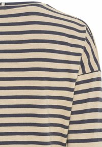 Beige and dark blue horizontally striped fabric, showing shoulder and sleeve area of a garment.