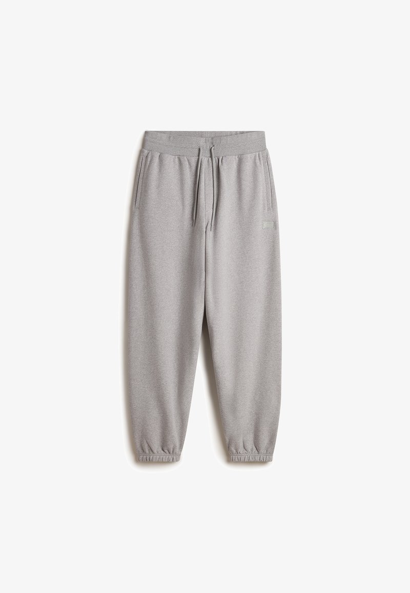 Graue Jogginghosen aus weichem Material, mit einem elastischen Bund und Kordelzug, seitlichen Taschen und elastischen Bündchen an den Knöcheln.