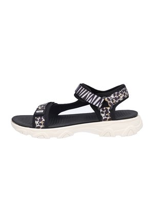 Sandalia de dedo abierta con estampado en blanco y negro, tiras ajustables y suela gruesa blanca, diseñada para uso casual.