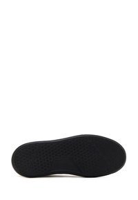 Black rubber shoe sole with a textured pattern. Features a rectangular grid and angled design elements, providing enhanced grip and stability.