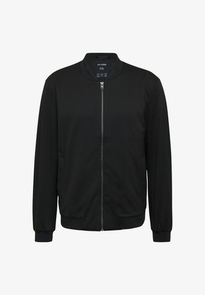 Veste bomber noire avec une fermeture éclair sur le devant, des poignets et un ourlet côtelés, et un col rond. Fabriquée en tissu lisse avec des poches latérales.