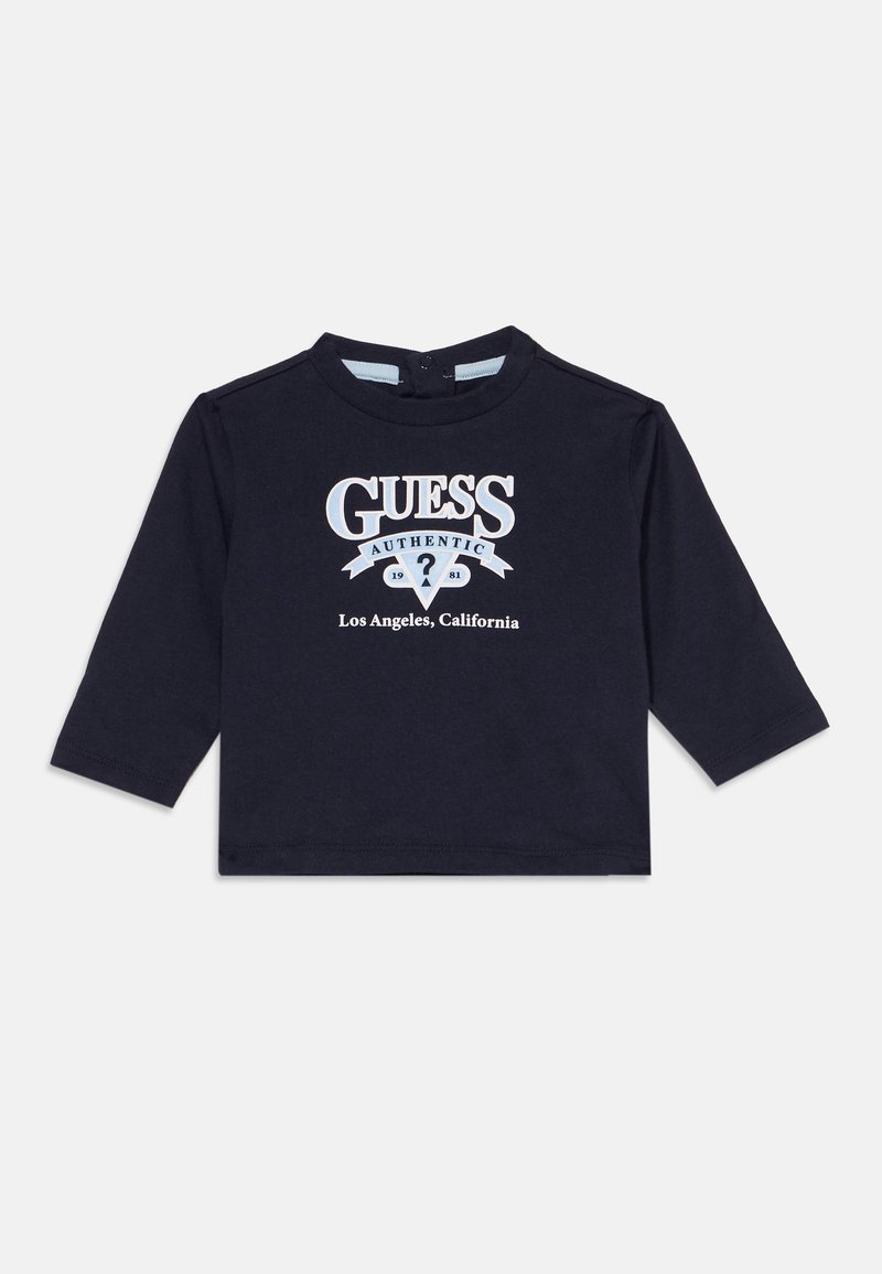 Μαύρο μακρυμάνικο παιδικό μπλουζάκι με το "GUESS Authentic 1981 Los Angeles, California" τυπωμένο σε λευκό και ανοιχτό μπλε μπροστά.