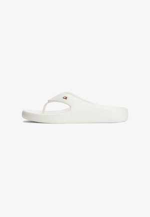 Witte teenslippers van glad rubber met een V-vormige band en een klein logo accent op de bovenkant. Lichtgewicht en minimalistisch ontwerp.