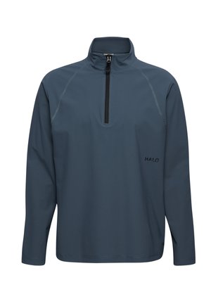 Mørkegrå bluse med lange ærmer, høj krave og halvlange lynlås foran, tekstureret stof og lille "HALO"-logo på brystet.