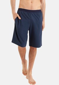 Shorts bleu marine en tissu doux, dotés d'une taille élastique et de poches latérales, avec une coupe ample et décontractée.