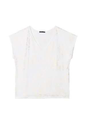 Haut blanc à col en V avec des manches courtes, arborant un motif subtil de feuilles dorées. Fabriqué dans un tissu doux, avec une coupe décontractée et une texture lisse.