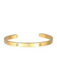 Bracciale a manchetto in metallo placcato oro con finitura liscia, caratterizzato da tre cristalli trasparenti e un emblema decorativo. Marcato "925 Ag" sul lato interno.