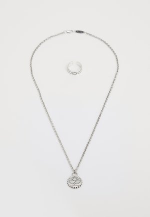 Silver necklace featuring a pendant with a sun and wave design, accompanied by a matching silver ring with a textured band.
