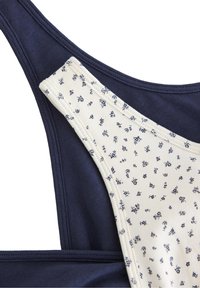 Αθλητικό σουτιέν σε ναυτικό μπλε και εκρού, με λουλουδάτο μοτίβο στο εκρού τμήμα και λεία υφή, με αντίθετους ιμάντες.