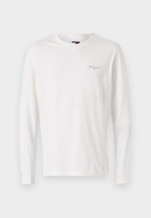 White long-sleeve T-shirt made of cotton, featuring a crew neckline and a small embroidered logo on the left chest. Soft texture.