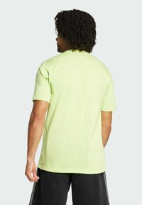 Light green cotton t-shirt with short sleeves, a round neckline, and a smooth texture, displayed from the back.