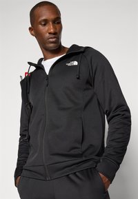 The North Face REAXION HOODED FULL ZIP JACKET - Športna jakna/jopica - black heather