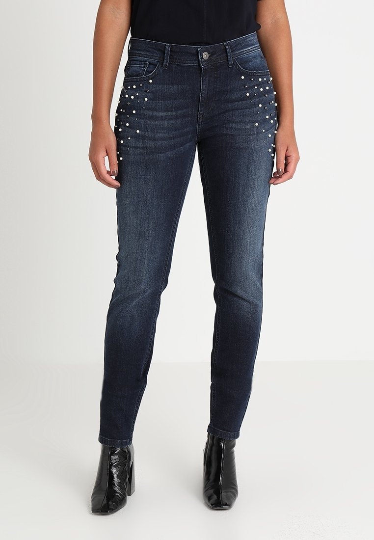 Tummat denim skinny farkut, joissa on keskitason vyötärö. Edessä on teksturoitu helmikoristus taskuilla ja ne ovat sileäpintaiset.