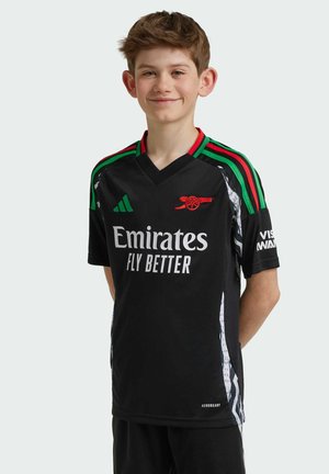 Maglietta da football nera a maniche corte con spalle a strisce verdi e rosse, caratterizzata da un logo "Emirates" bianco e dal emblema dell'Arsenal, con dettagli testurizzati.