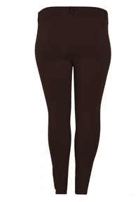 Braune Leggings aus dehnbarem Stoff mit glatter Textur, slim fit und einem einfachen, elastischen Bund ohne Taschen oder Verzierungen.