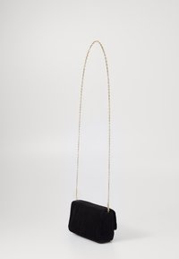 Čierna zamatová crossbody taška so zlatým reťazovým popruhom. Obdĺžnikový tvar, jemná textúra a minimalistický dizajn bez viditeľného hardvéru.