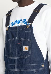 Carhartt WIP BIB OVERALL - Laisvo kirpimo džinsai - blue one wash
