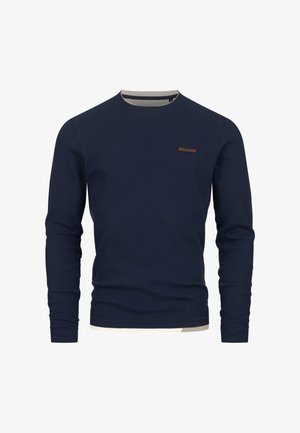 Marineblauwe geribde trui met lange mouwen, voorzien van een ronde hals en een bruine accent op de linkerborst. Zachte textuur en aansluitend ontwerp.