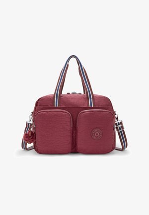 Red nylon bag with two front pockets, a textured finish, dual handles, and a striped adjustable shoulder strap. Features a keychain monkey.
